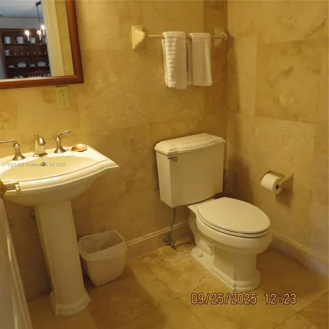 a white toilet sitting next to a bathroom sink