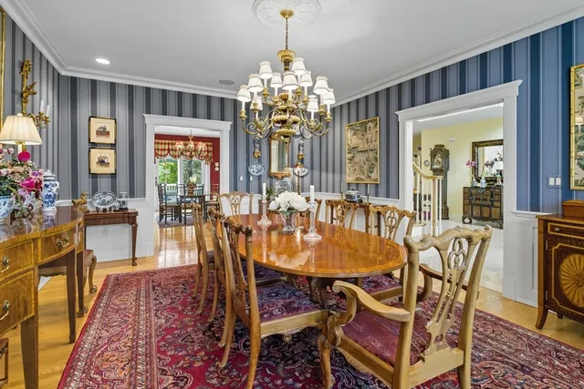 a dining room with furniture a chandelier and wooden floor