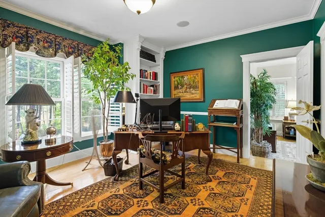 a living room with fireplace furniture and a large window