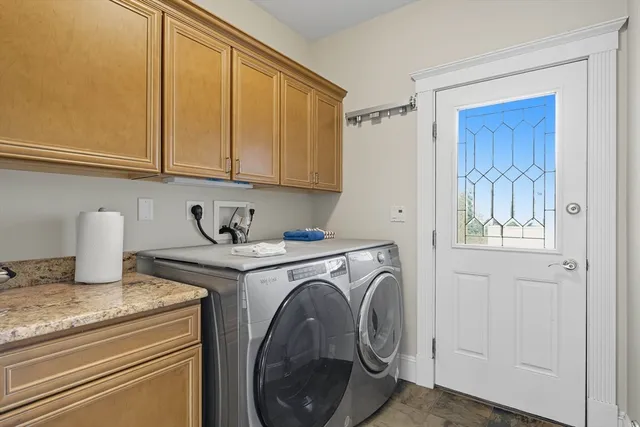 a utility room with sink dryer and washer