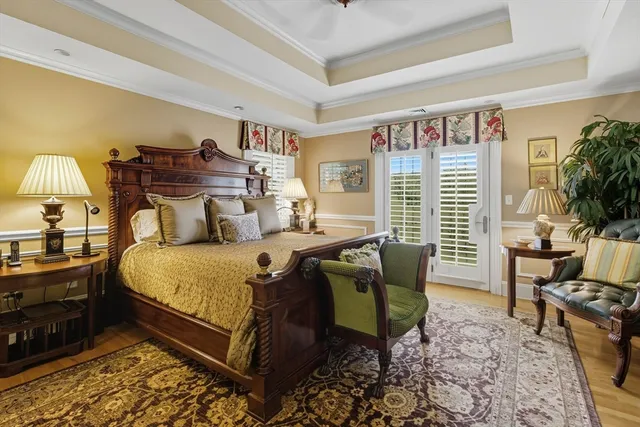 a bedroom with furniture and a large window