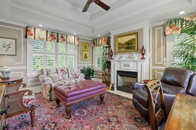 a living room with furniture a flat screen tv and a fireplace