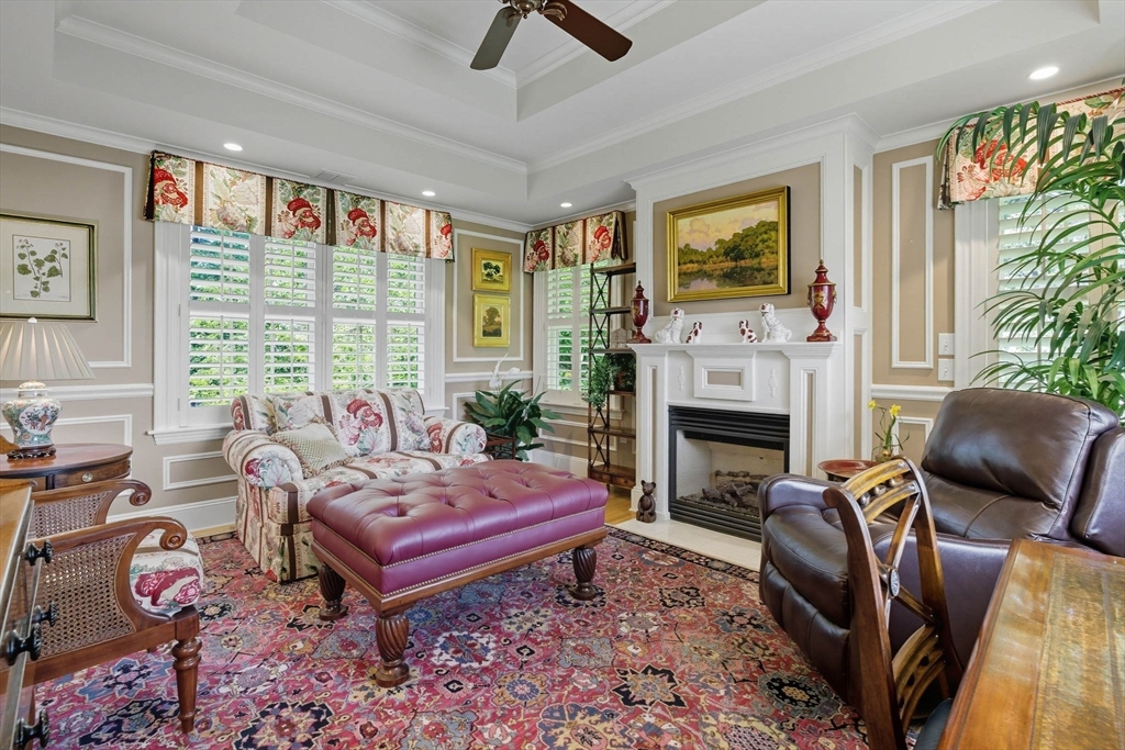 3 Warren Drive Middleton, MA 01949 - Photo 29 of 42 a living room with furniture a flat screen tv and a fireplace