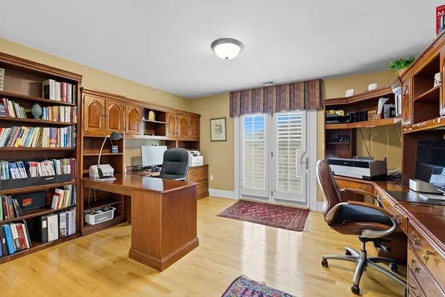 a view of a workspace with furniture and a bookshelf