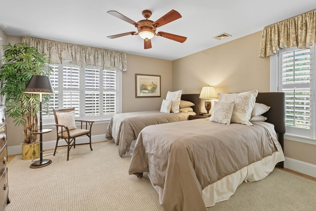 3 Warren Drive Middleton, MA 01949 - Photo 35 of 42 a bedroom with a bed a chandelier and a large window