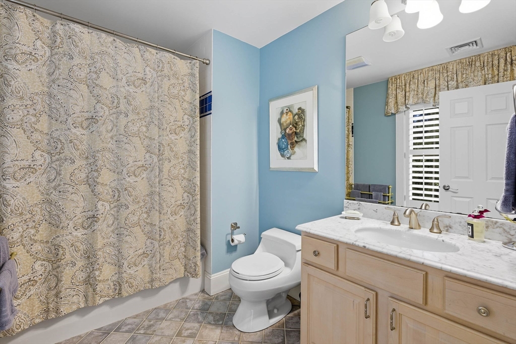 3 Warren Drive Middleton, MA 01949 - Photo 36 of 42 a bathroom with a granite countertop sink a toilet and a mirror