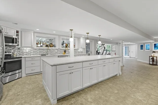 a spacious bathroom with a granite countertop sink and a mirror