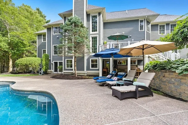a patio with a table and chairs under an umbrella