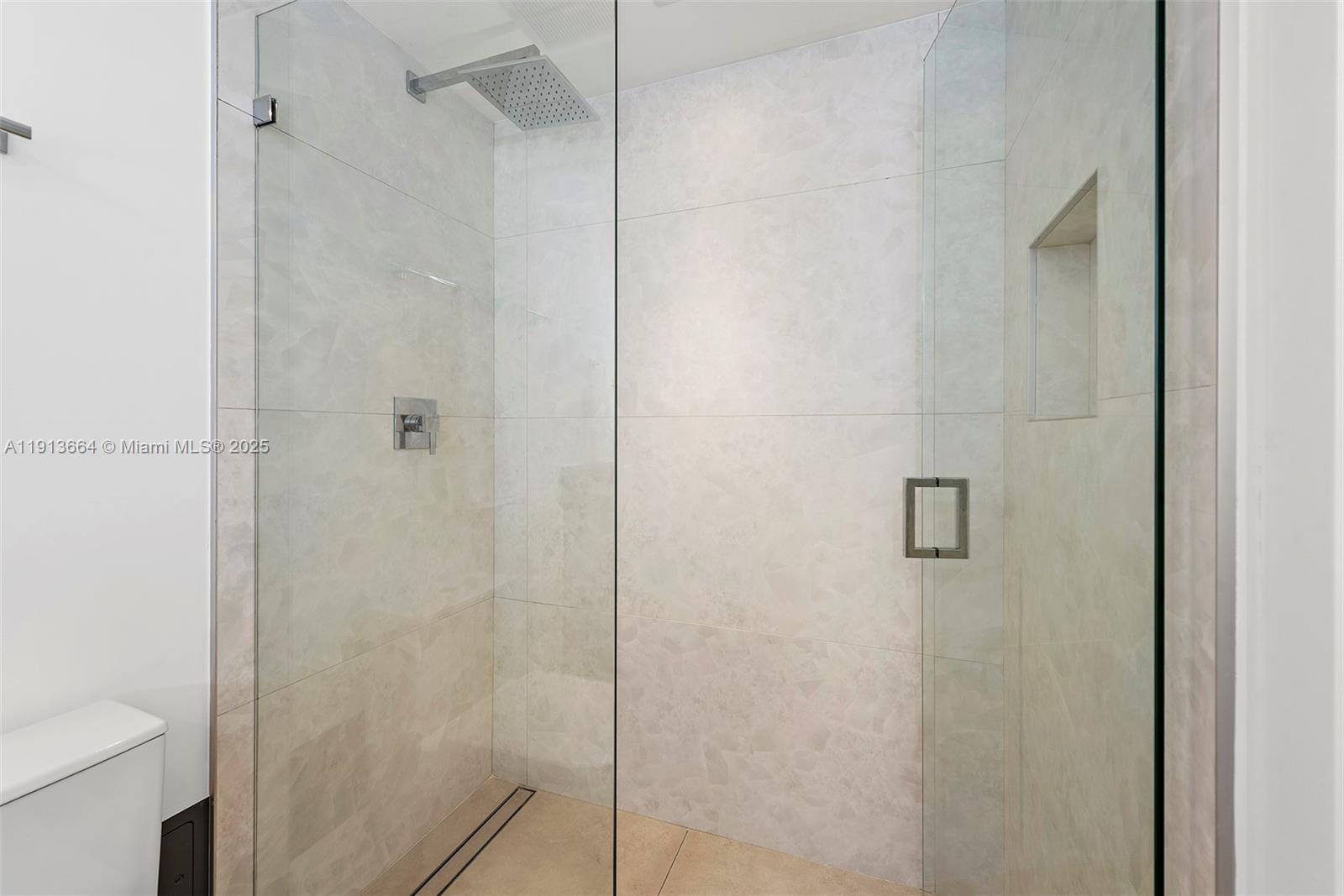 2301 Collins Avenue, Unit 1004 Miami Beach, FL 33139 - Photo 17 of 53 a bathroom with a shower and a toilet