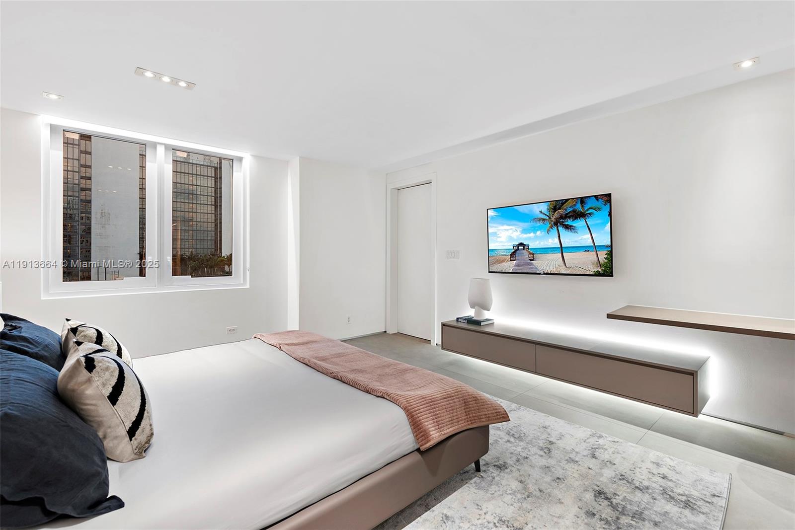 2301 Collins Avenue, Unit 1004 Miami Beach, FL 33139 - Photo 20 of 53 a bedroom with a bed and a large window