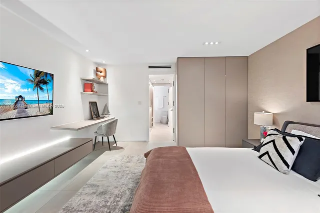 a bedroom with a bed and painting on the wall