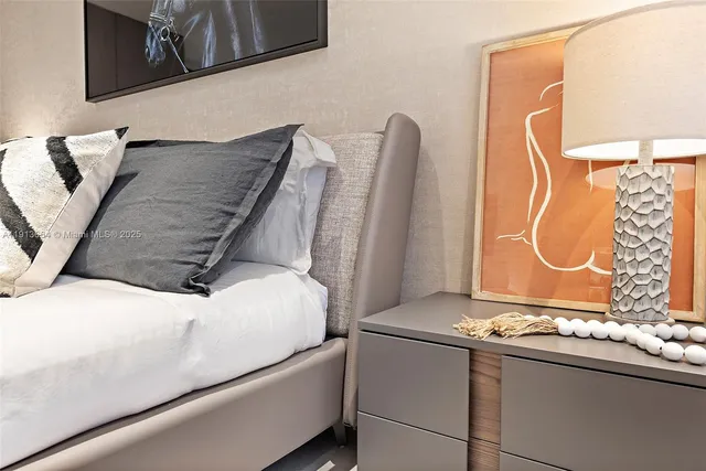 a bedroom with a bed and a wall painting