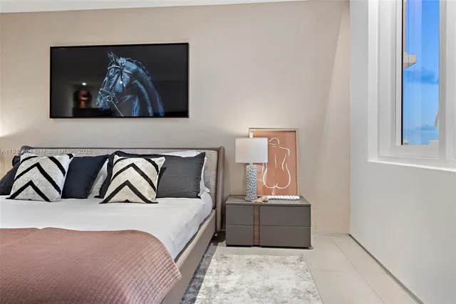 a bedroom with a bed and a chair