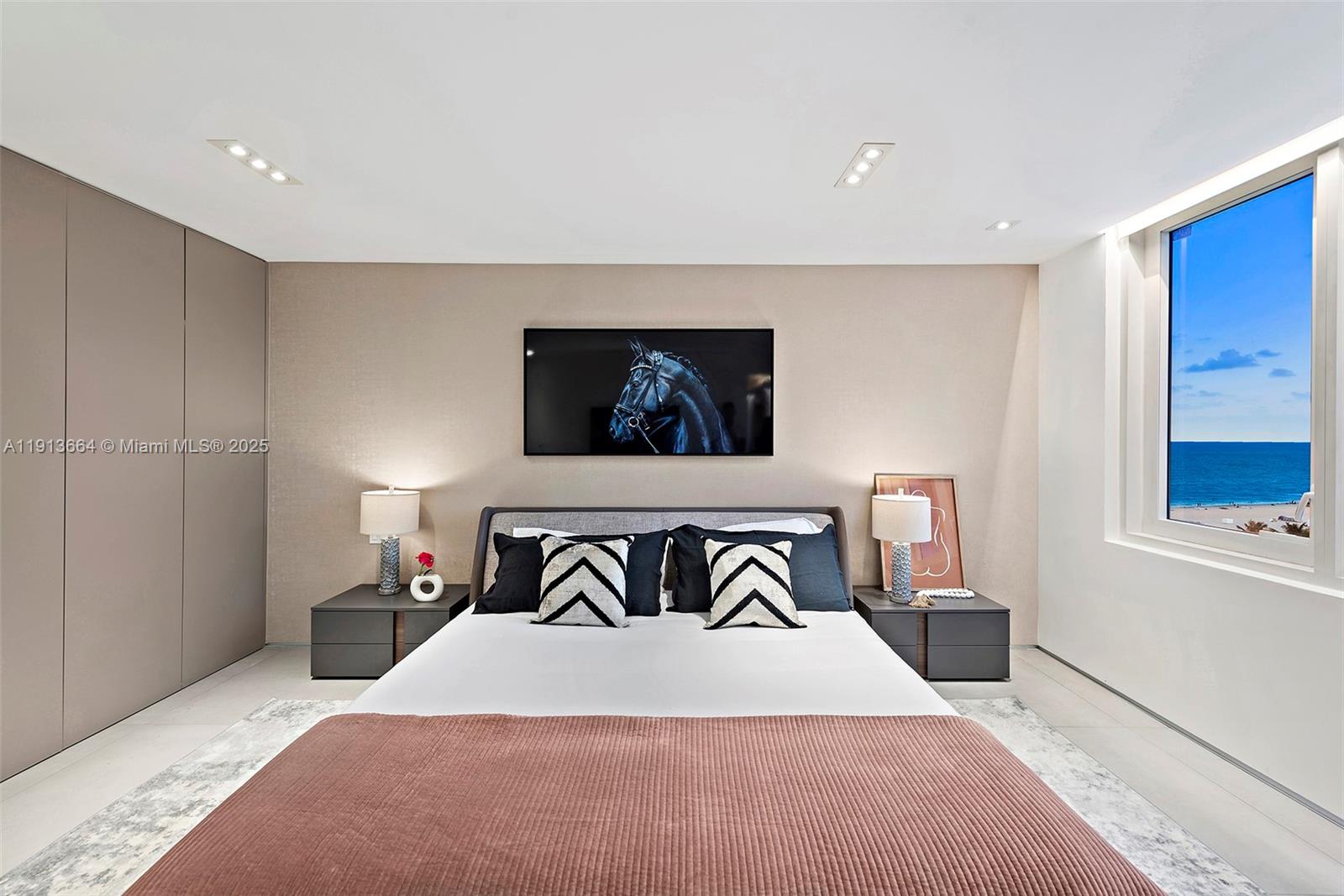 2301 Collins Avenue, Unit 1004 Miami Beach, FL 33139 - Photo 24 of 53 a bedroom with a bed and a wall painting