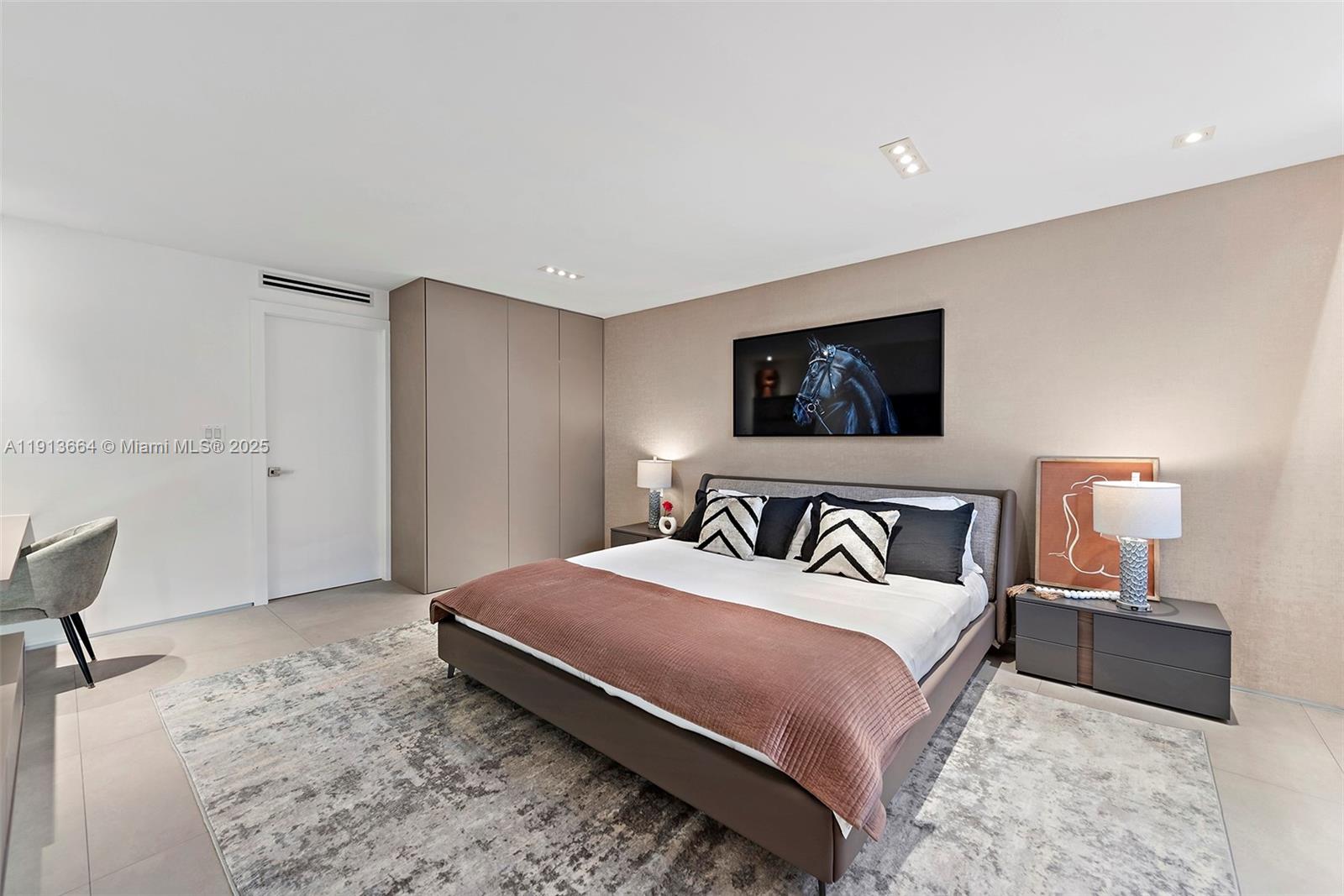 2301 Collins Avenue, Unit 1004 Miami Beach, FL 33139 - Photo 25 of 53 a bedroom with a bed and a chair