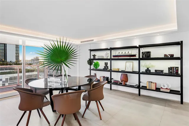 a living room with furniture and view of kitchen