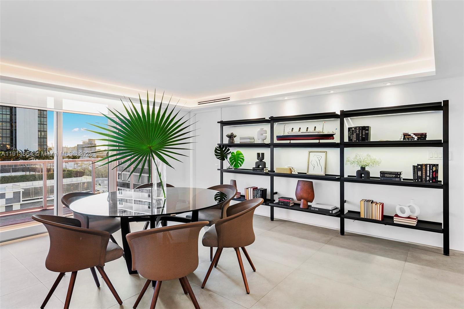 2301 Collins Avenue, Unit 1004 Miami Beach, FL 33139 - Photo 35 of 53 a dining room with furniture and a potted plant