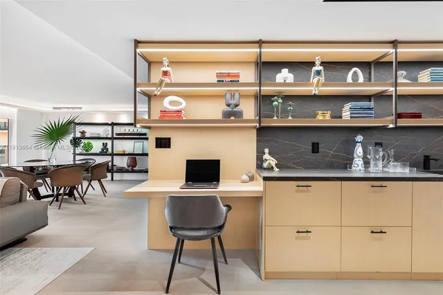 a kitchen with stainless steel appliances granite countertop a refrigerator and wooden cabinets