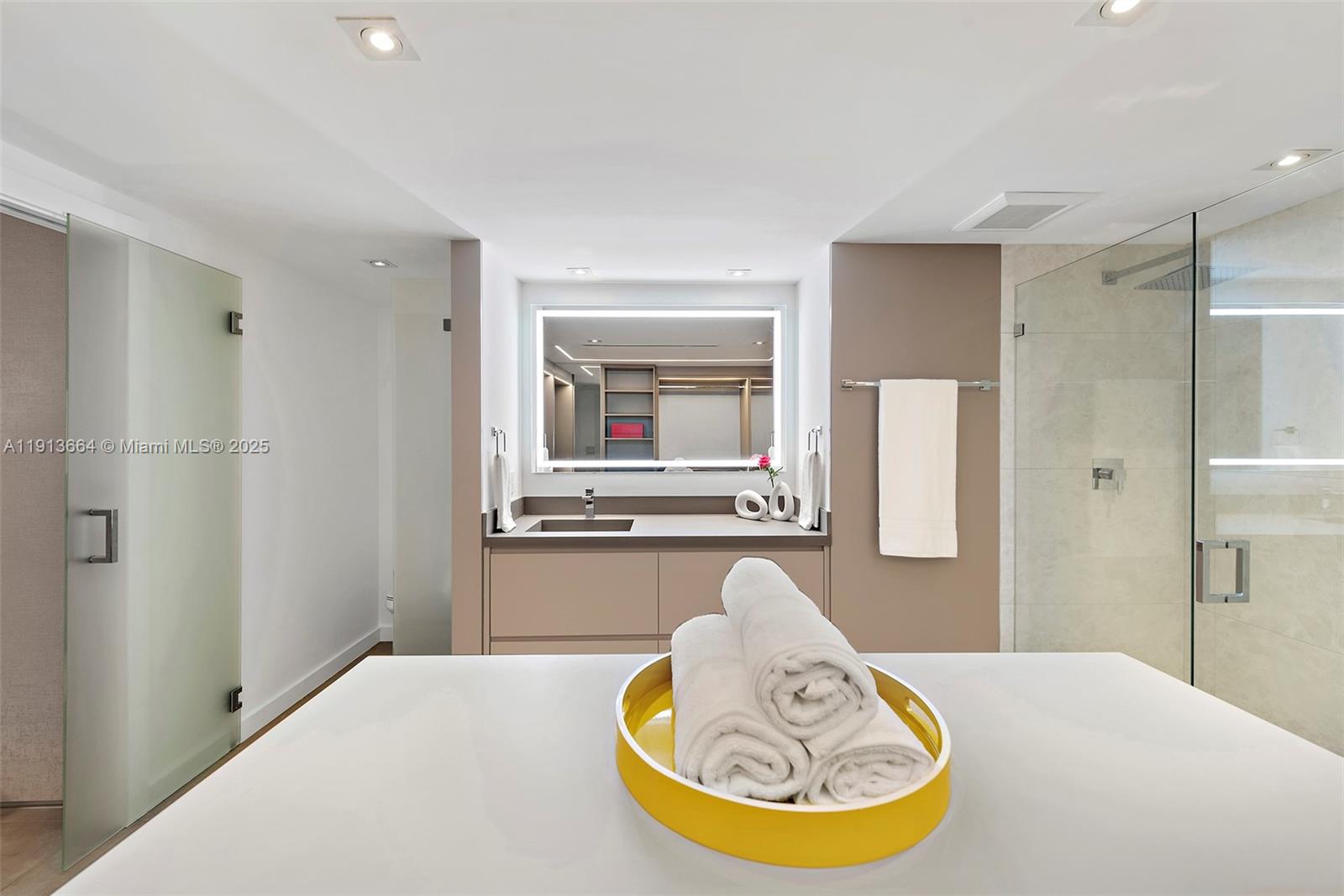 2301 Collins Avenue, Unit 1004 Miami Beach, FL 33139 - Photo 4 of 53 a bathroom with a tub sink and mirror