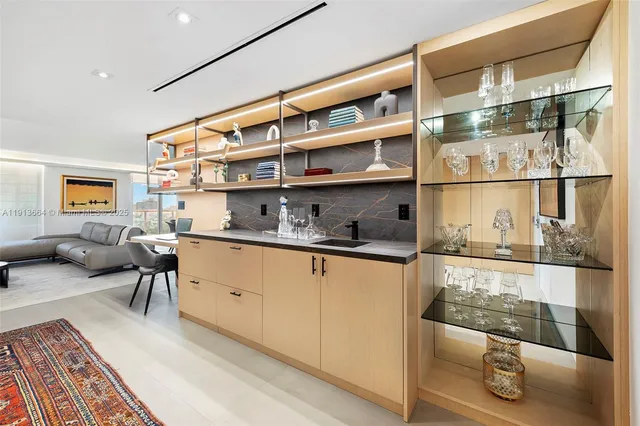 a living room with stainless steel appliances furniture and a rug