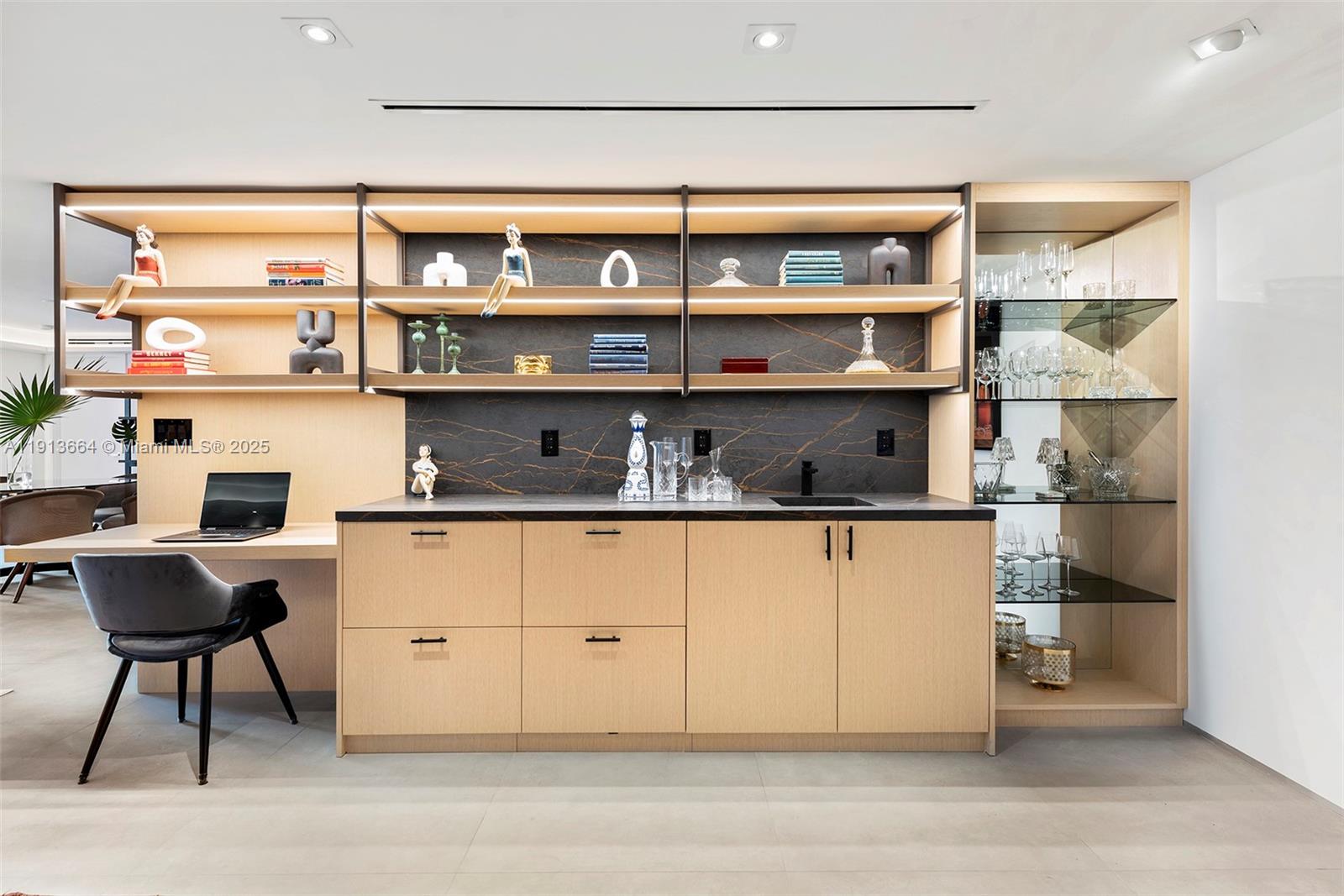 2301 Collins Avenue, Unit 1004 Miami Beach, FL 33139 - Photo 43 of 53 a kitchen with a table and chair