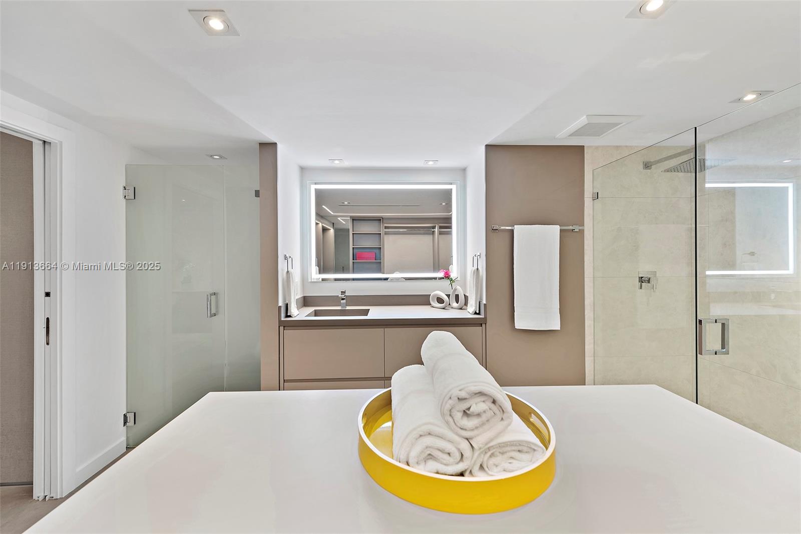 2301 Collins Avenue, Unit 1004 Miami Beach, FL 33139 - Photo 5 of 53 a bathroom with a tub and a mirror