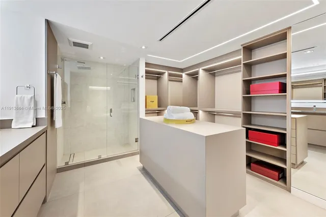 a bedroom with a large bed and a lamp