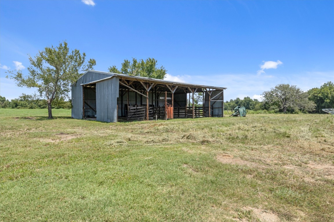 451 Pleasant Grove Road Elgin, TX 78621 - Photo 13 of 26 a view of a house with backyard and trees