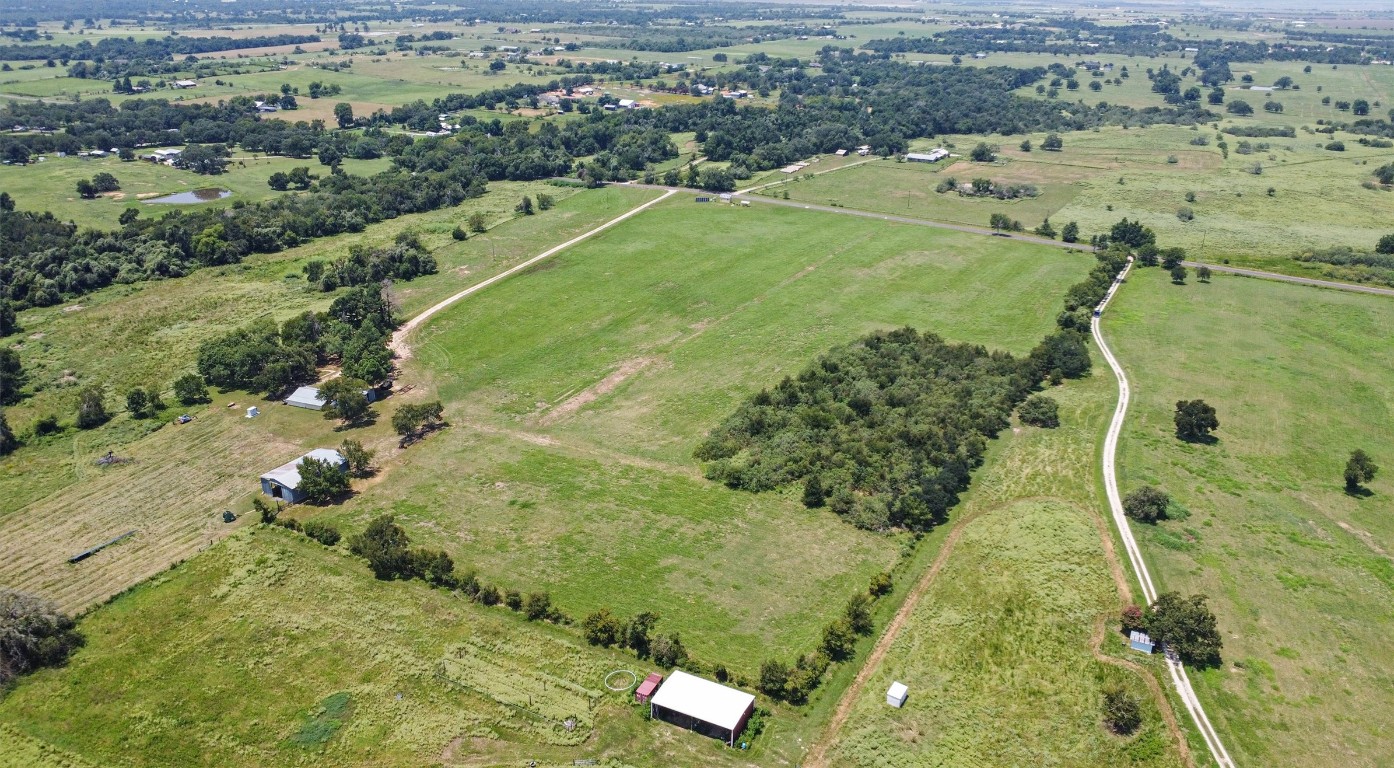 451 Pleasant Grove Road Elgin, TX 78621 - Photo 18 of 26 an aerial view of residential houses with outdoor space
