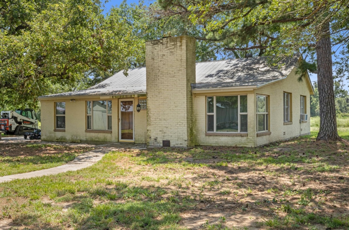 451 Pleasant Grove Road Elgin, TX 78621 - Photo 2 of 26 a view of a house with a garden
