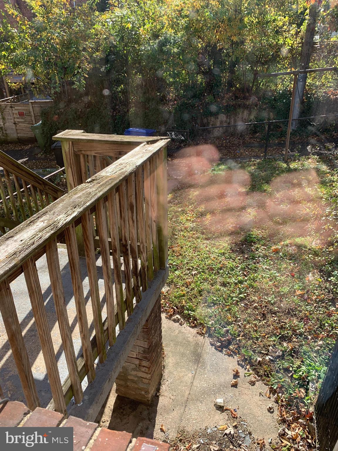 929 East 41st Street Baltimore, MD 21218 - Photo 17 of 18 a view of a small yard with wooden fence
