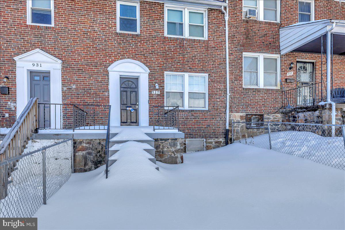 929 East 41st Street Baltimore, MD 21218 - Photo 4 of 18 a front view of a house with outdoor seating