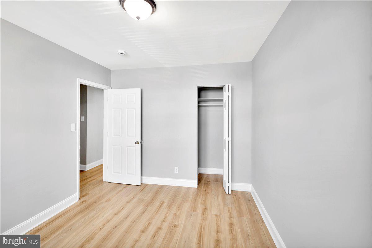 929 East 41st Street Baltimore, MD 21218 - Photo 9 of 18 a view of an empty room with wooden floor