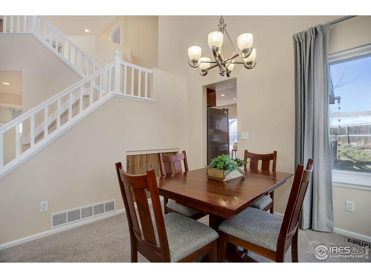 1244 Lambert Circle Lafayette, CO 80026 - Photo 6 of 39 a view of a dining room with furniture and a chandelier