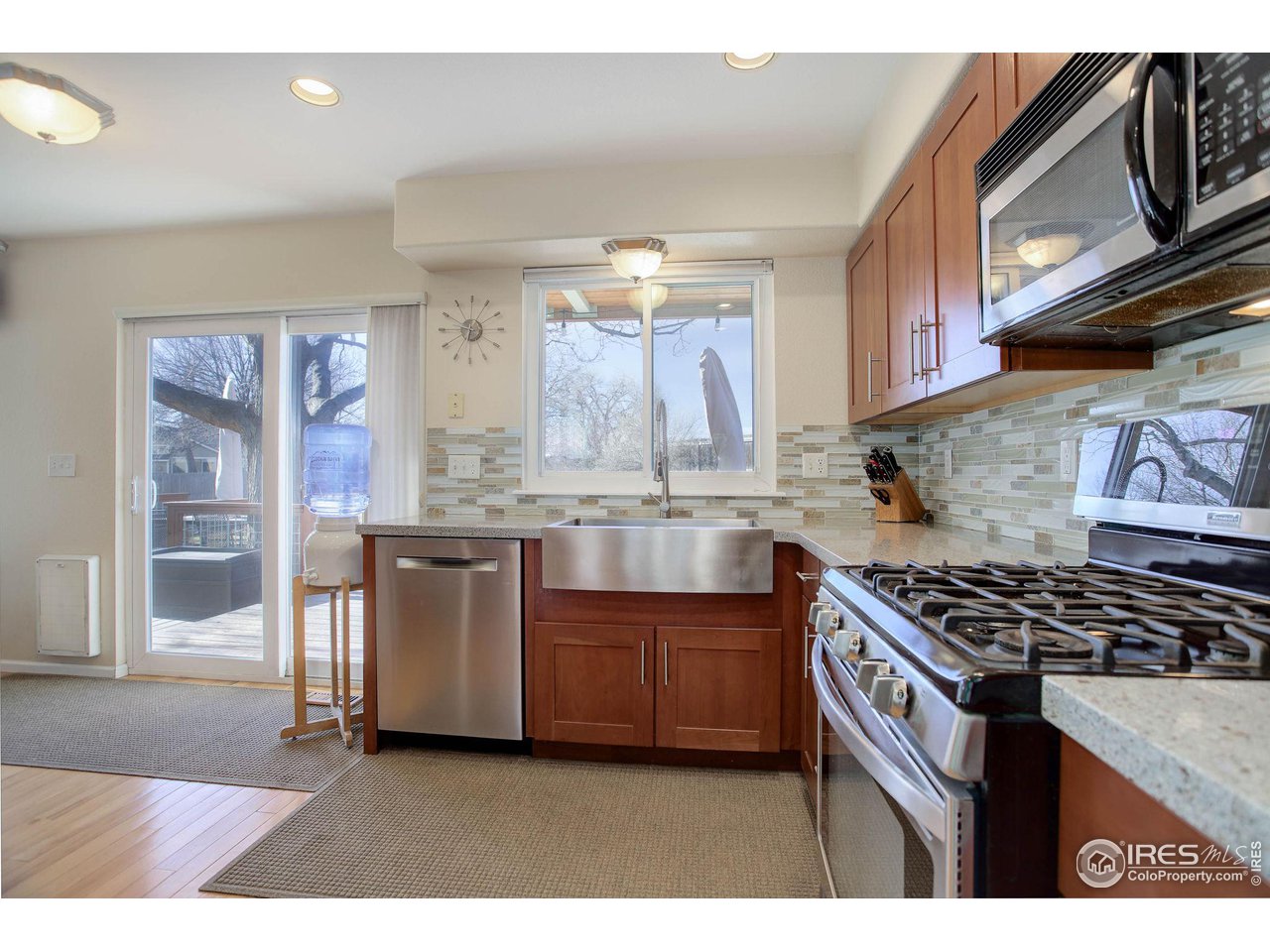 1244 Lambert Circle Lafayette, CO 80026 - Photo 9 of 39 a kitchen with stainless steel appliances granite countertop a stove a sink and a microwave
