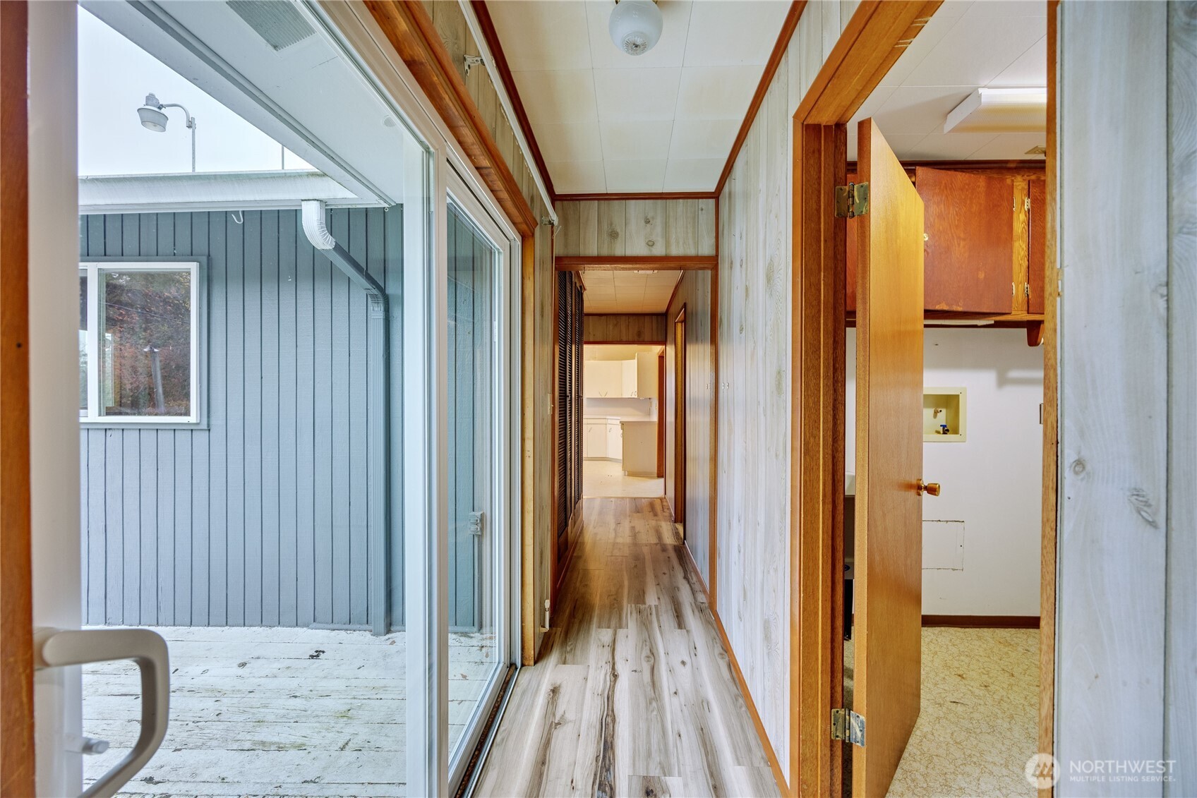 2703 Anderson Hill Road Southwest Port Orchard, WA 98367 - Photo 19 of 27 a view of a hallway with wooden floor and a bathroom