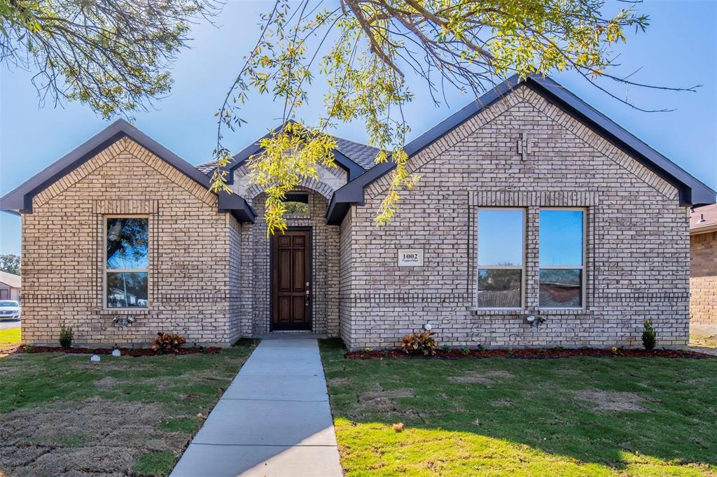 1002 Pepperidge Drive Lancaster, TX 75134 - Photo 1 of 1 a front view of a house with a garden and plants