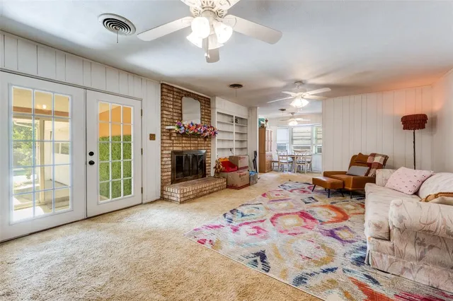a bedroom with furniture and a large window