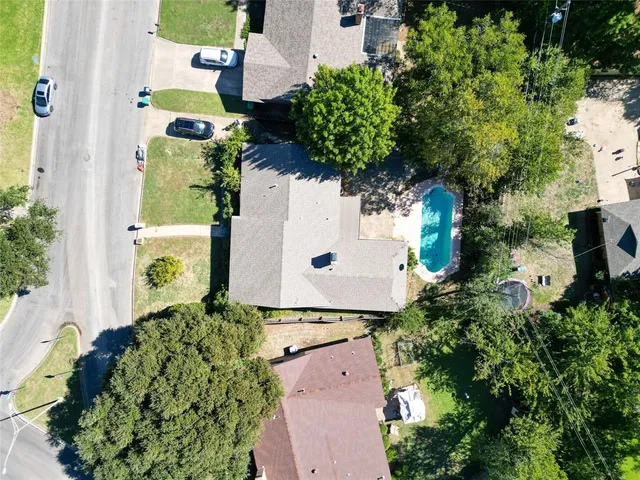 an aerial view of a house with a yard and garden