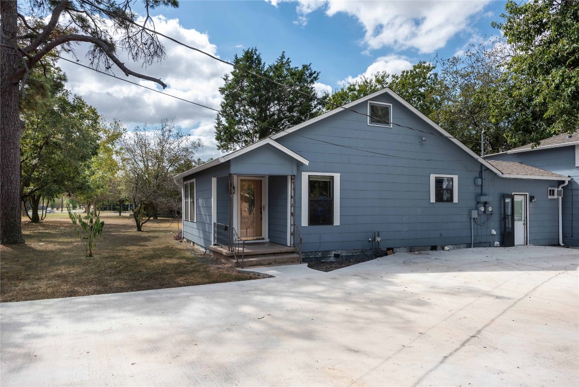 406 Lexington Road, Unit 1 Elgin, TX 78621 - Photo 1 of 1 a view of a house with yard and trees in the background