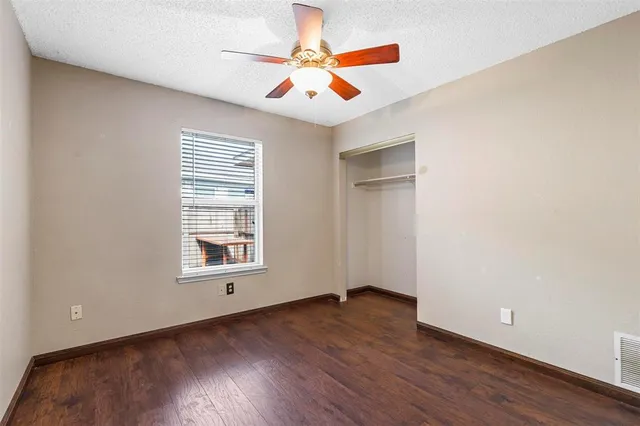 a bathroom with a toilet sink vanity and mirror
