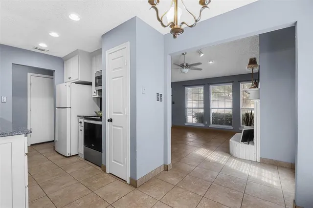 a view of a kitchen with a refrigerator and a sink