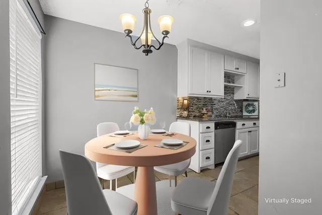a view of a dining room with furniture and chandelier