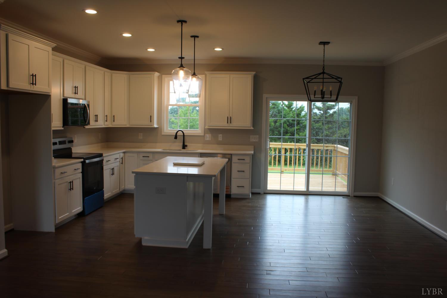 1493 Buck Crk Road Appomattox, VA 24522 - Photo 11 of 18 a kitchen with a sink a center island cabinets and a window