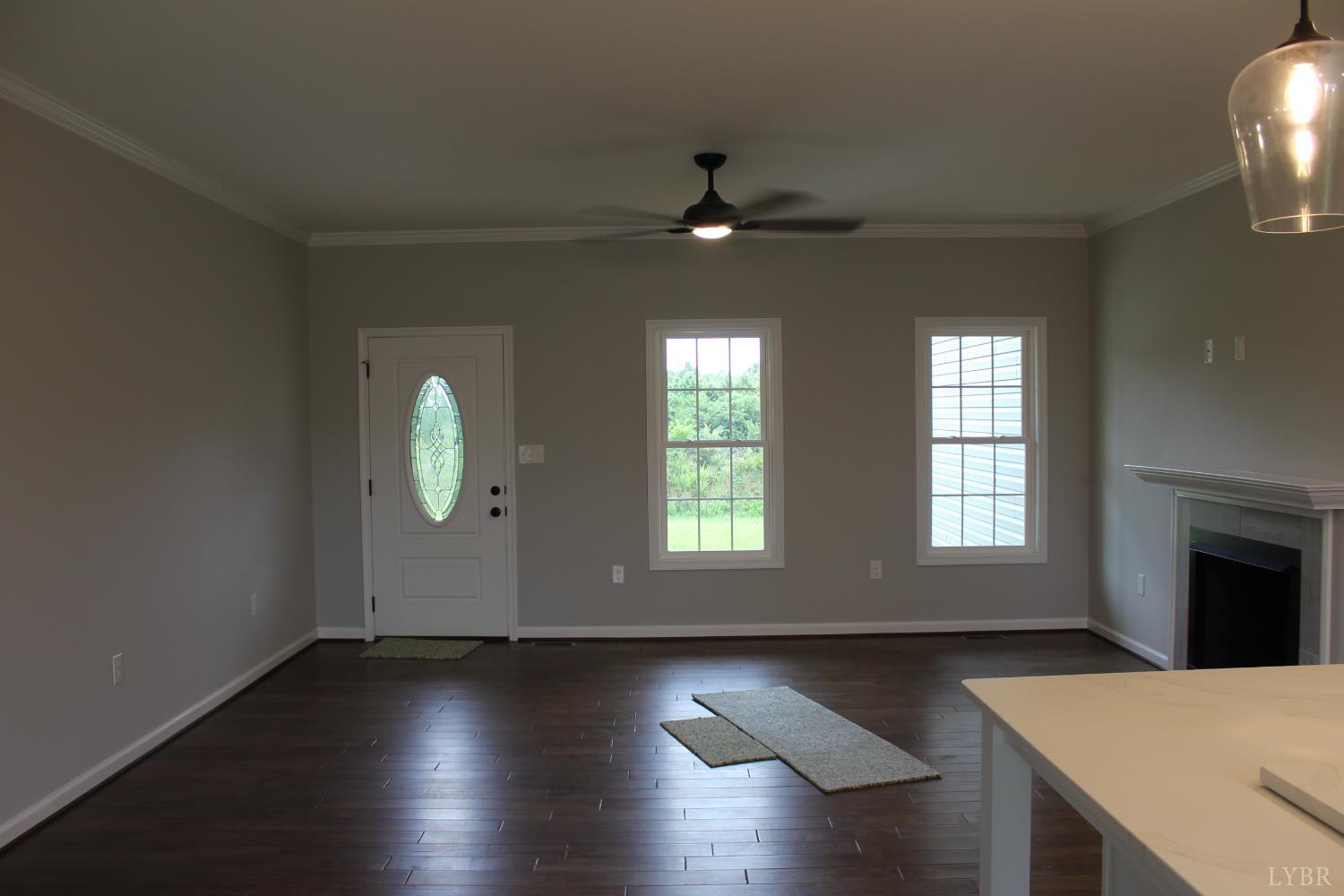 1493 Buck Crk Road Appomattox, VA 24522 - Photo 14 of 18 an empty room with wooden floor and windows