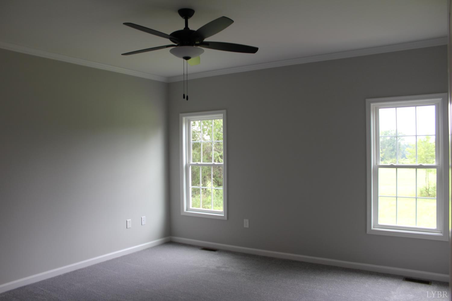 1493 Buck Crk Road Appomattox, VA 24522 - Photo 17 of 18 an empty room with windows and fan