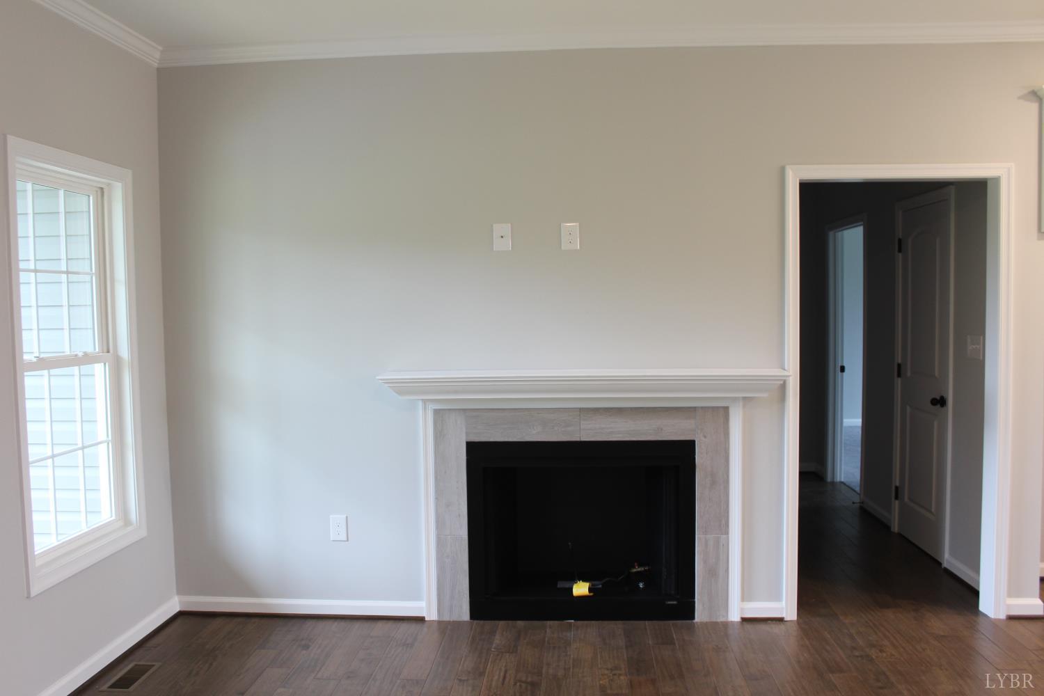 1493 Buck Crk Road Appomattox, VA 24522 - Photo 7 of 18 an empty room with a fireplace and window