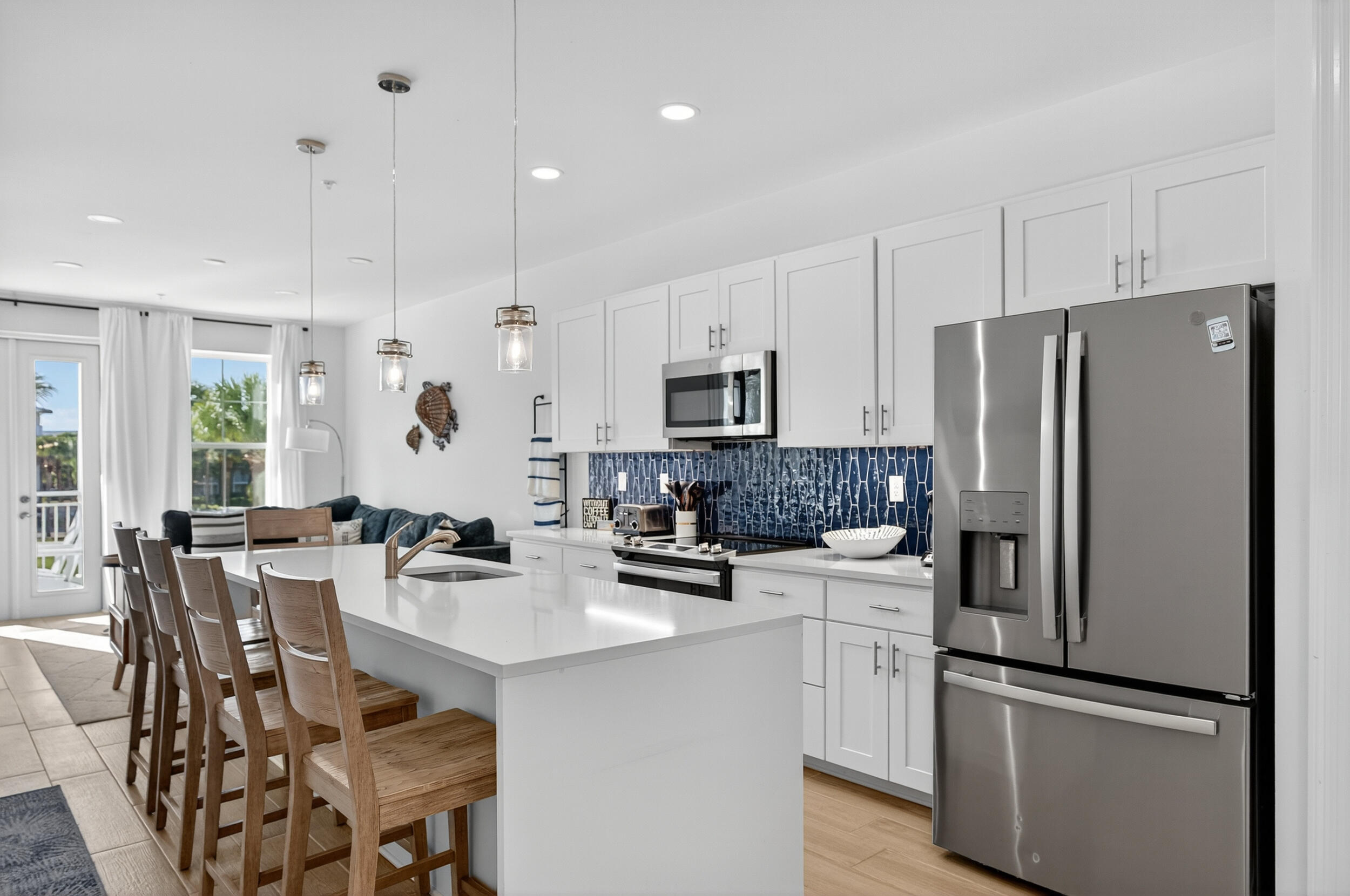 1740 South Co Highway 393, Unit 103 Santa Rosa Beach, FL 32459 - Photo 11 of 73 a kitchen with white cabinets and stainless steel appliances