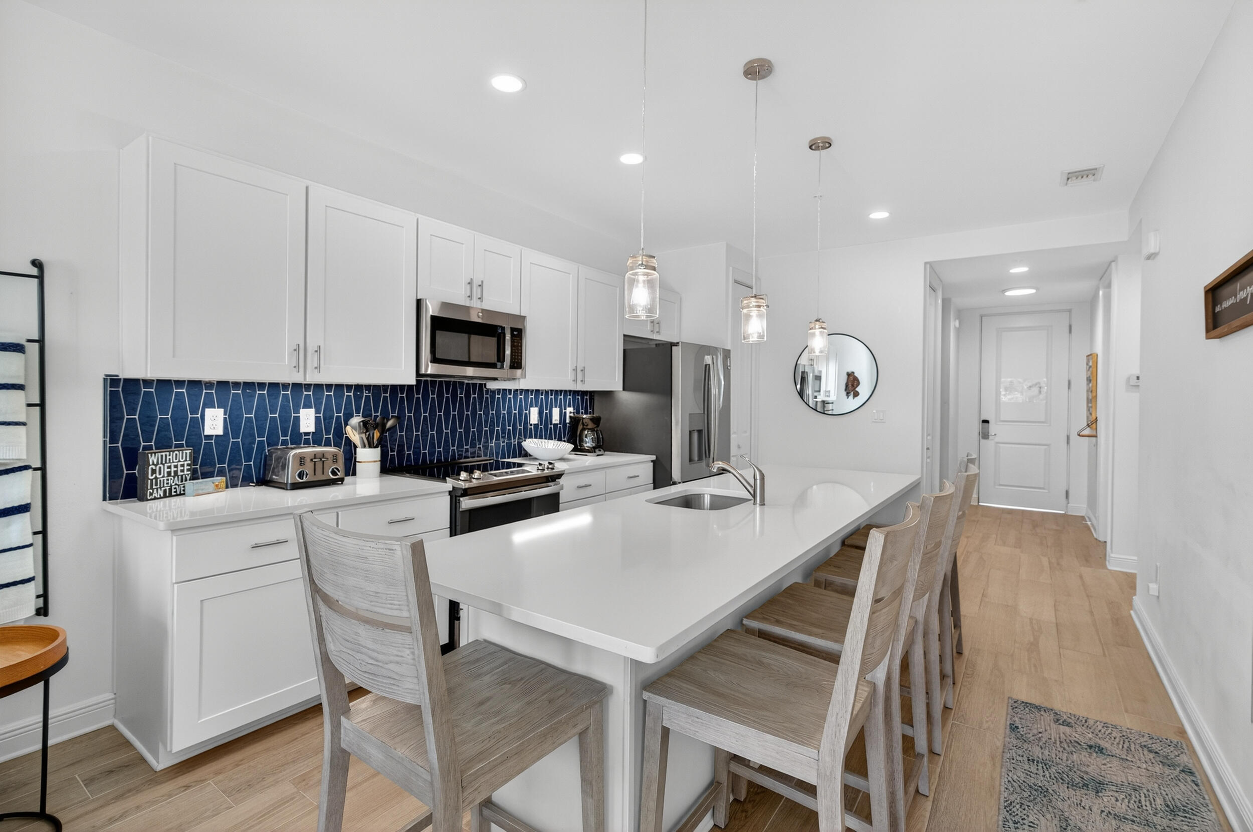 1740 South Co Highway 393, Unit 103 Santa Rosa Beach, FL 32459 - Photo 15 of 73 a kitchen with a dining table cabinets and stainless steel appliances