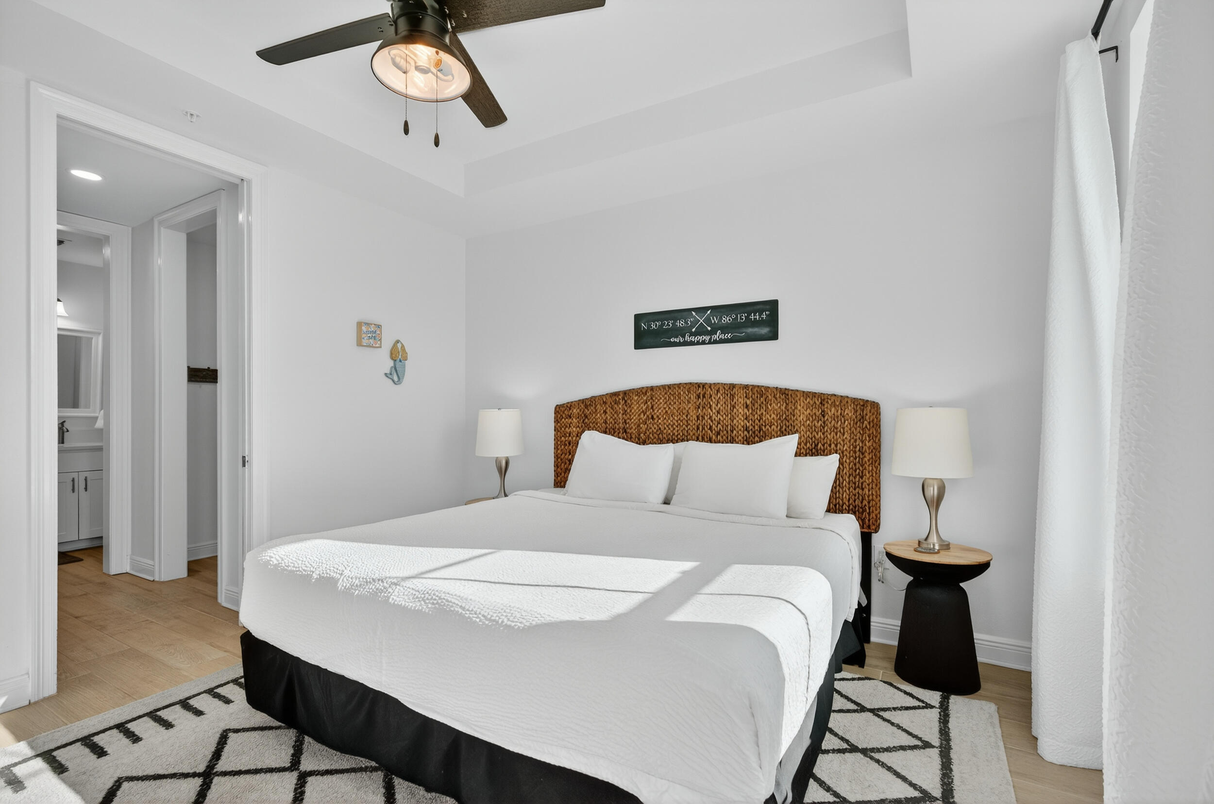 1740 South Co Highway 393, Unit 103 Santa Rosa Beach, FL 32459 - Photo 22 of 73 a bedroom with a bed and a chandelier